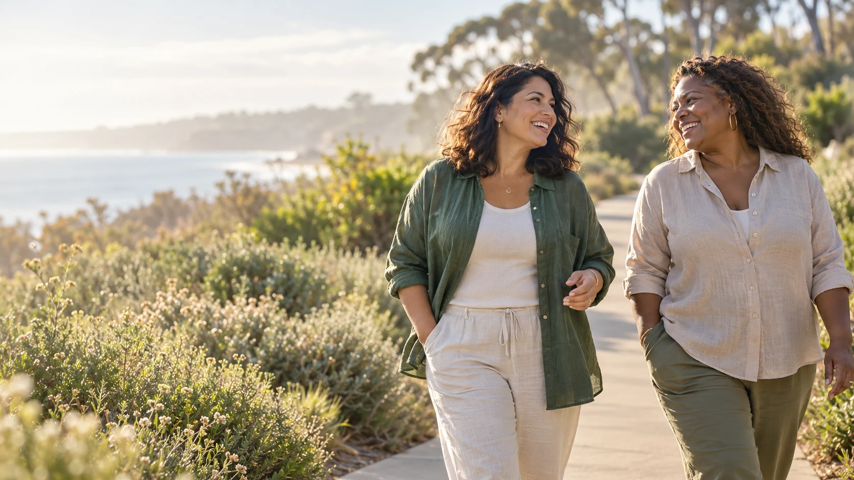 Two women enjoying a morning walk beside the California coast.
